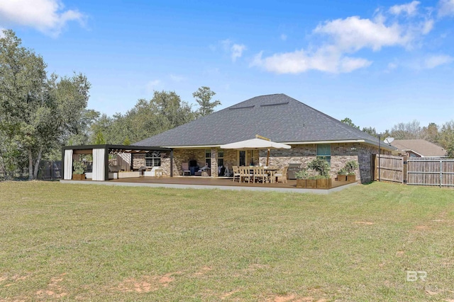 rear view of property featuring a patio, fence, and a yard