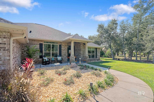 exterior space with a patio area and a front lawn