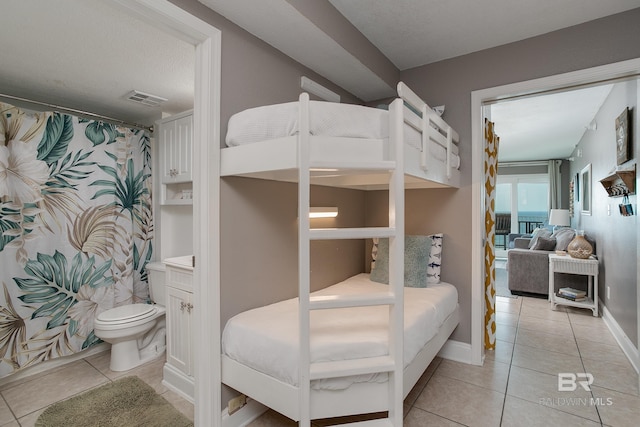 bedroom with light tile patterned floors