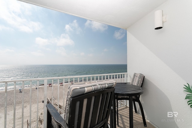 balcony featuring a water view and a view of the beach