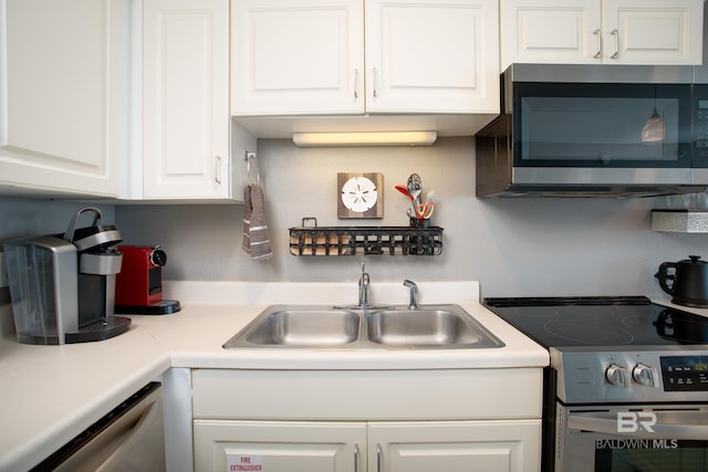 kitchen featuring appliances with stainless steel finishes, sink, and white cabinets