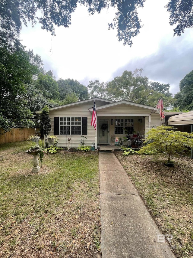 view of front facade with a front lawn and a porch