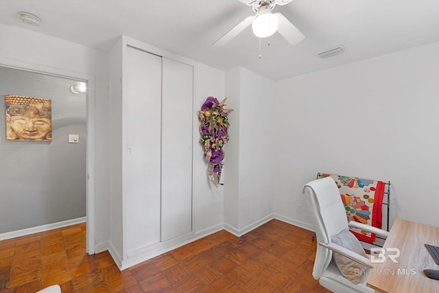 office space with ceiling fan and dark parquet flooring