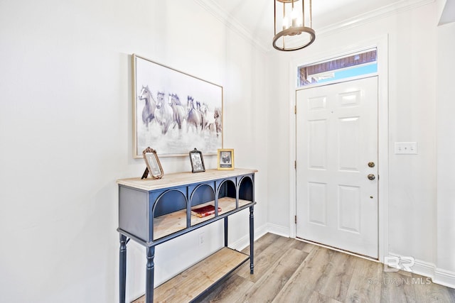 foyer with hardwood / wood-style floors and crown molding