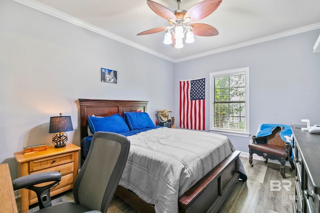 bedroom featuring ceiling fan, hardwood / wood-style flooring, and crown molding