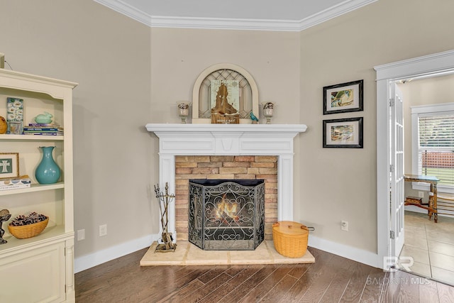 interior space featuring crown molding, dark wood-type flooring, and a brick fireplace