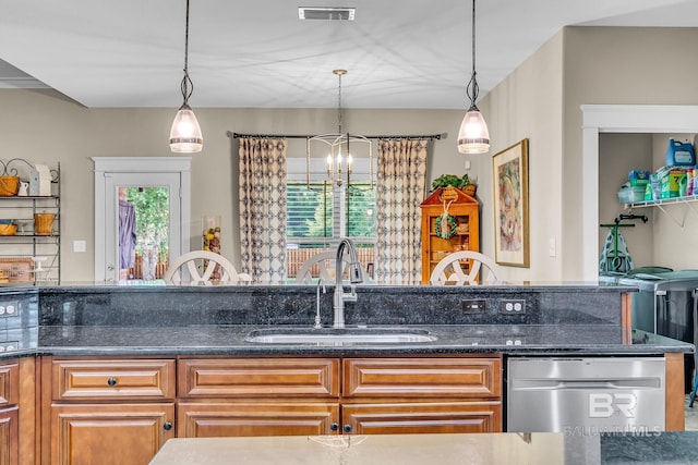 kitchen with sink, dark stone countertops, and pendant lighting