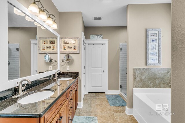 bathroom with tile patterned floors, vanity, and separate shower and tub