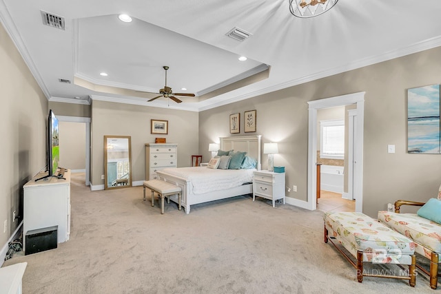 bedroom featuring crown molding, ensuite bathroom, ceiling fan, a raised ceiling, and light colored carpet