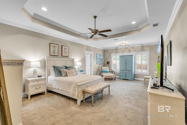 carpeted bedroom featuring ceiling fan, a tray ceiling, and crown molding