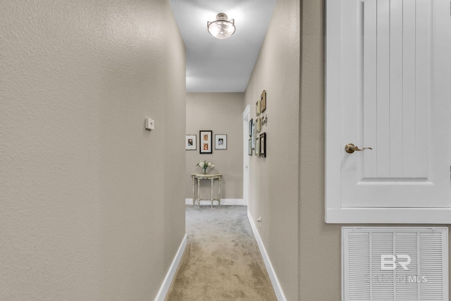 hallway with light colored carpet