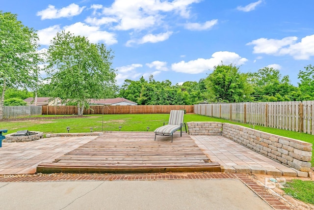 view of patio featuring a wooden deck and a fire pit