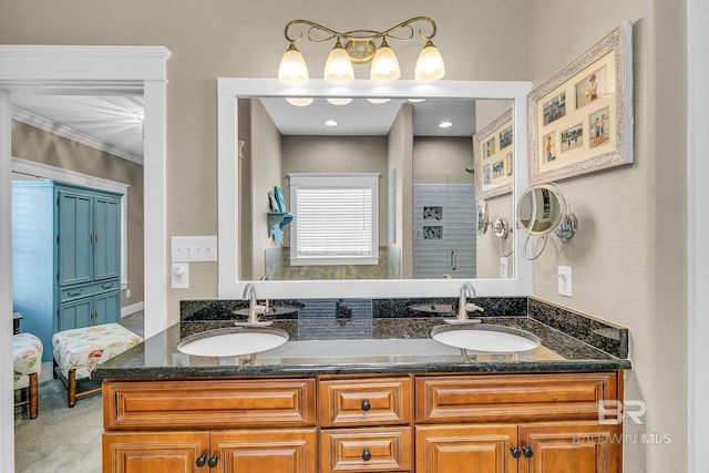 bathroom with crown molding, walk in shower, and vanity