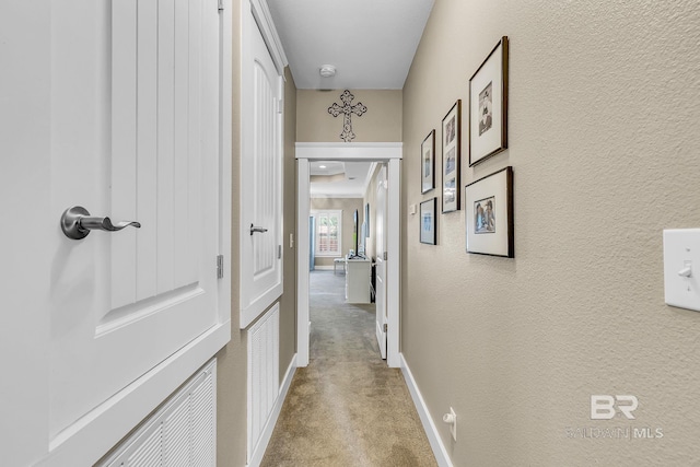 hallway with light colored carpet