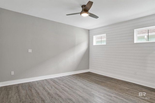 unfurnished room featuring ceiling fan and dark hardwood / wood-style flooring