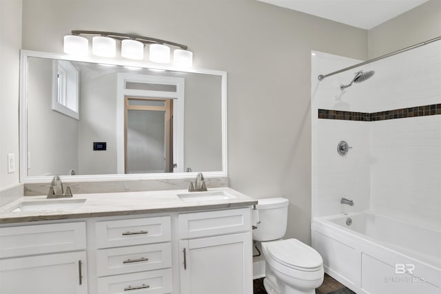 full bathroom with toilet, tiled shower / bath, and vanity