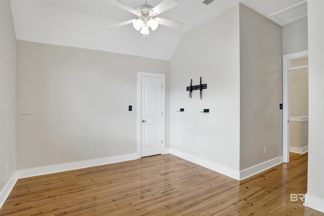 spare room featuring lofted ceiling, ceiling fan, and hardwood / wood-style flooring