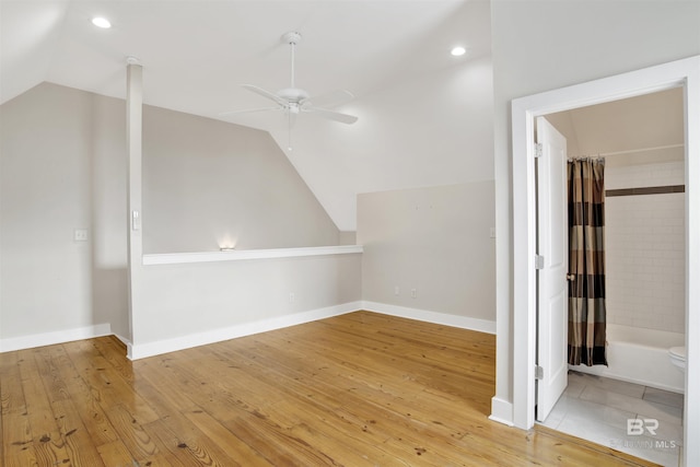 additional living space featuring lofted ceiling, ceiling fan, and hardwood / wood-style flooring