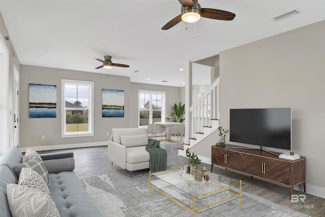 living room featuring ceiling fan and hardwood / wood-style flooring