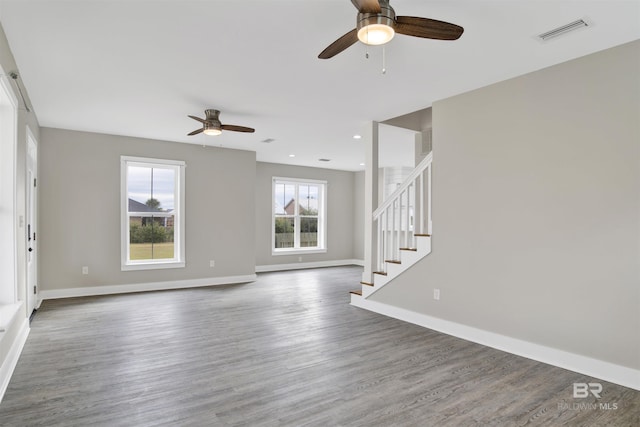 unfurnished living room with ceiling fan and dark hardwood / wood-style floors