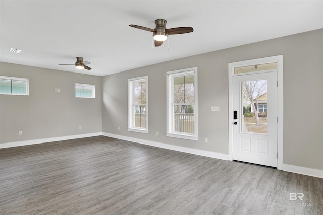 foyer with ceiling fan and wood-type flooring