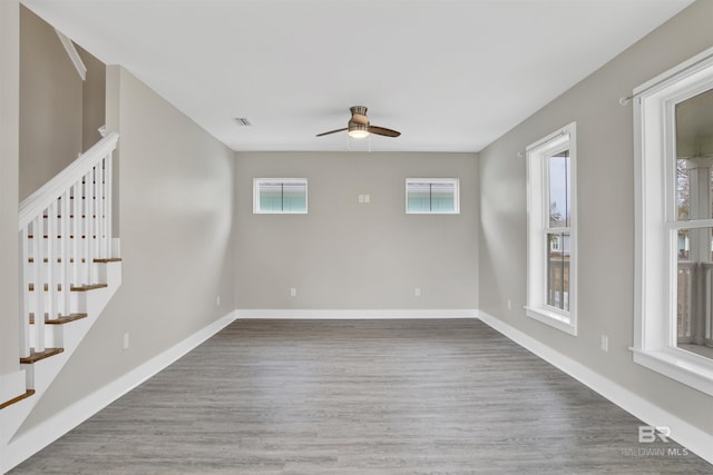 spare room with ceiling fan and dark hardwood / wood-style floors