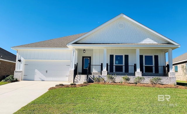 view of front facade featuring a front lawn, a porch, and a garage