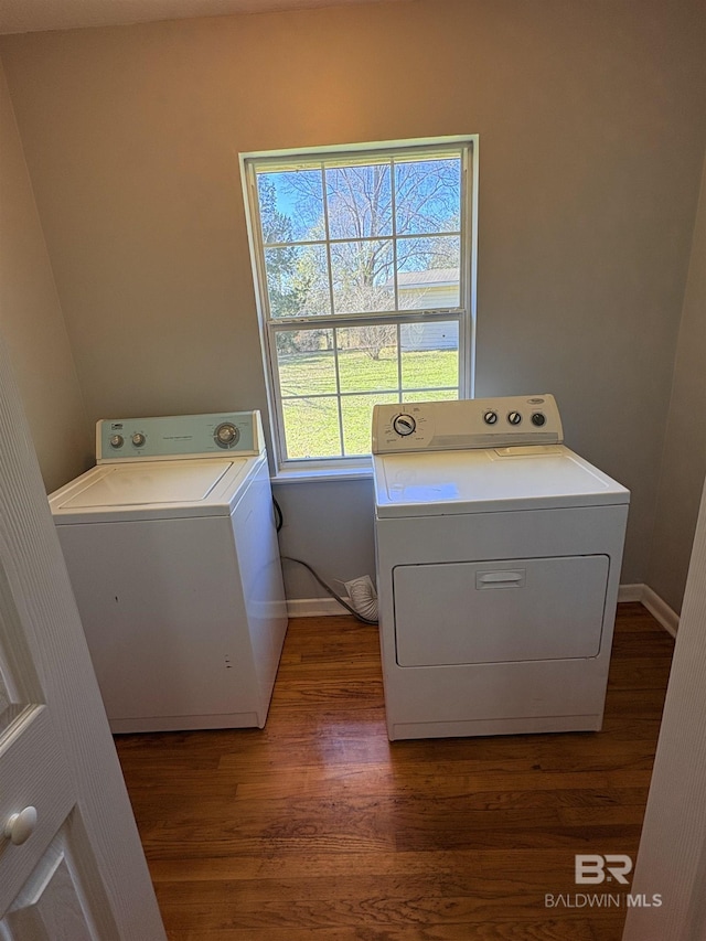 laundry room featuring dark wood-type flooring and washer and dryer