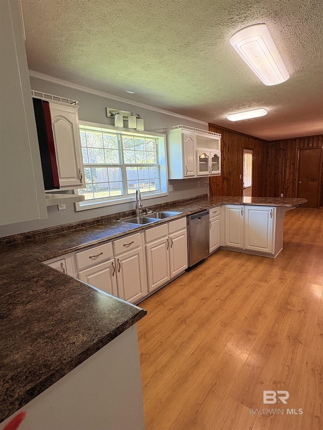 kitchen featuring sink, light hardwood / wood-style flooring, dishwasher, white cabinets, and kitchen peninsula