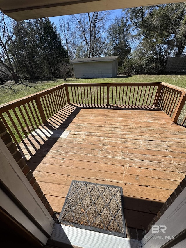 wooden terrace featuring a lawn