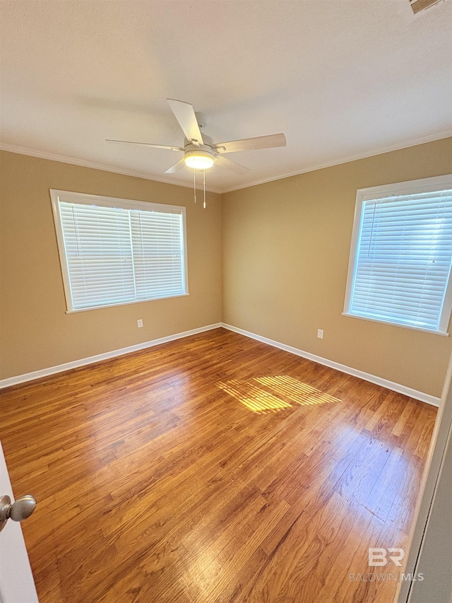 unfurnished room featuring ornamental molding, wood-type flooring, and ceiling fan