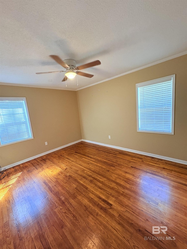 empty room featuring crown molding, ceiling fan, hardwood / wood-style floors, and a textured ceiling