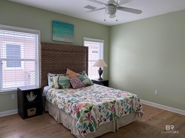 bedroom with ceiling fan and wood-type flooring