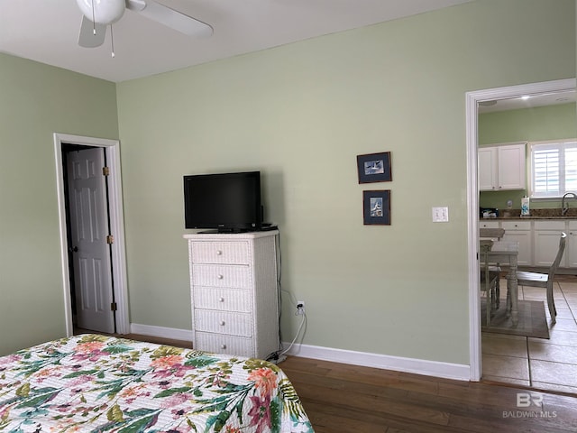 bedroom featuring ceiling fan and dark hardwood / wood-style floors