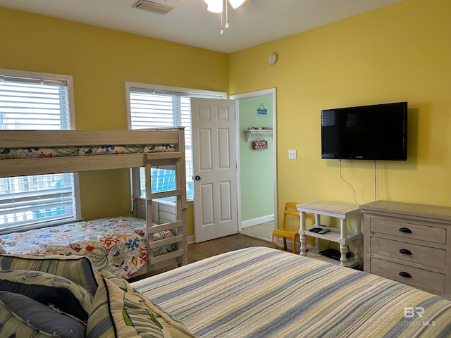 bedroom featuring wood-type flooring and multiple windows