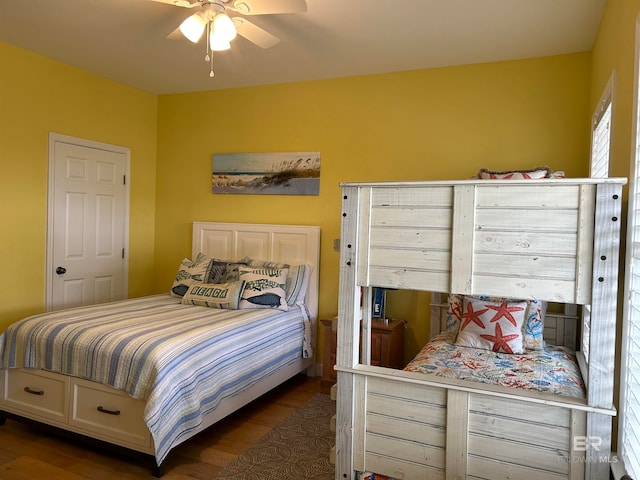 bedroom with ceiling fan and dark hardwood / wood-style flooring