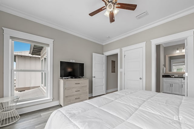 bedroom featuring visible vents, ensuite bath, ceiling fan, crown molding, and light wood-type flooring