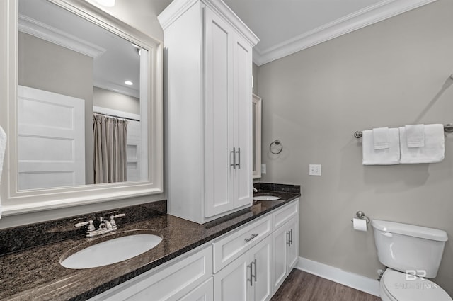 full bath with ornamental molding, a sink, baseboards, and double vanity