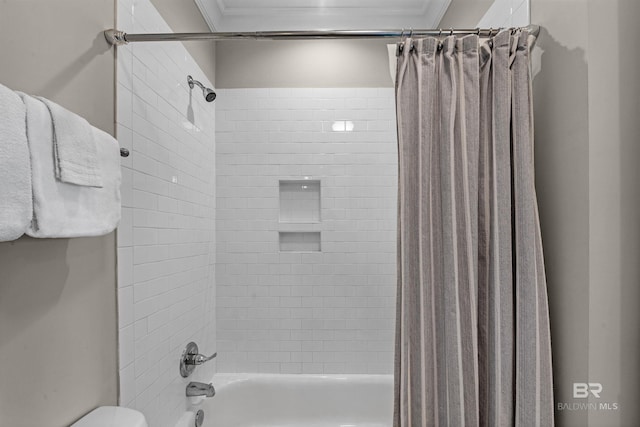 full bathroom with ornamental molding, shower / bath combo with shower curtain, and toilet