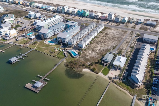 drone / aerial view with a water view and a beach view