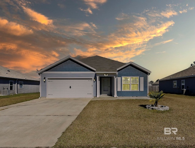 view of front of property featuring a yard, central AC, and a garage