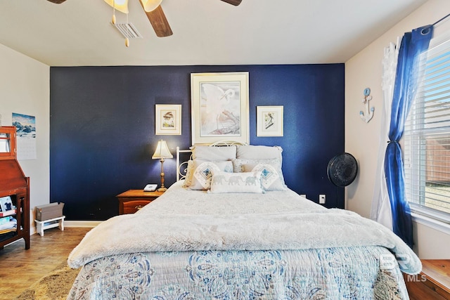 bedroom featuring hardwood / wood-style flooring and ceiling fan