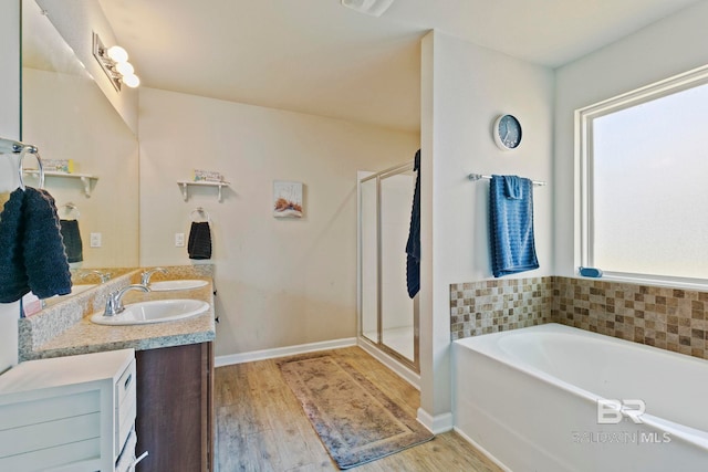 bathroom featuring hardwood / wood-style flooring, plenty of natural light, shower with separate bathtub, and vanity