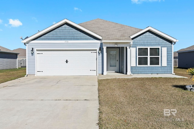 view of front facade with a garage and a front lawn