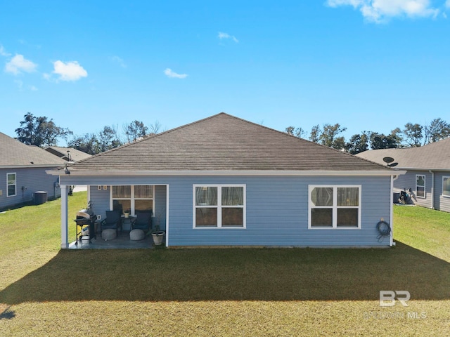 back of property featuring a lawn, a patio area, and central air condition unit