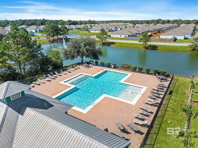 view of pool with a patio area and a water view