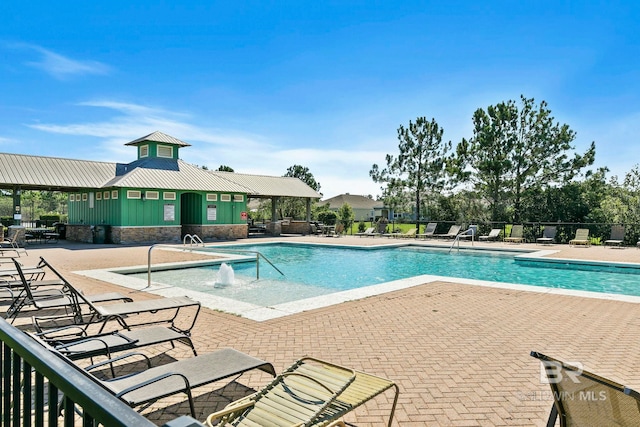 view of pool featuring pool water feature and a patio area