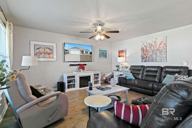 living room with wood-type flooring and ceiling fan