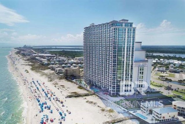 birds eye view of property featuring a beach view and a water view