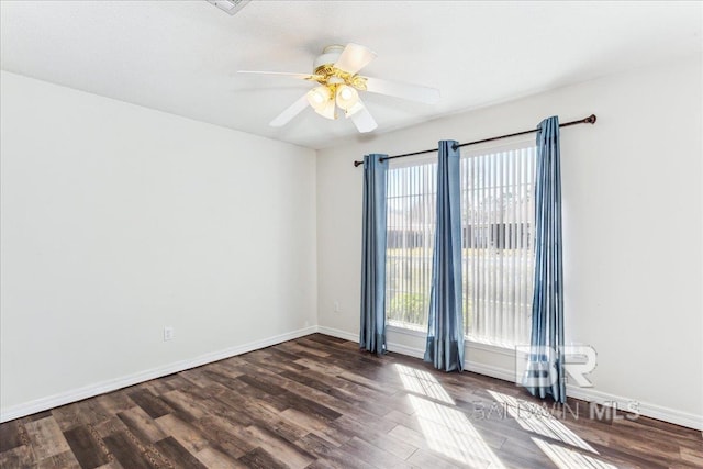 spare room with baseboards, a ceiling fan, and wood finished floors